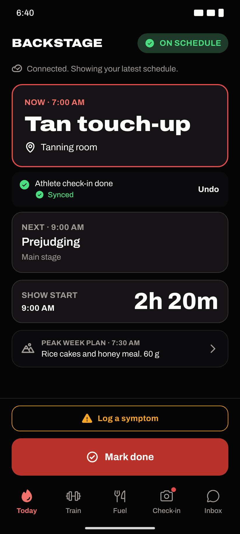 Show day in TOA, backstage and on schedule: now at 7:00 AM, tan touch-up in the tanning room; athlete check-in done and synced; next at 9:00 AM, prejudging on the main stage; show start in 2 hours 20 minutes; a Mark done button.